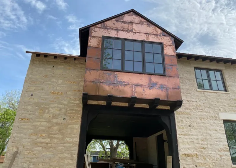 Copper metal panel facade on a stone building for Skylight Installation in Bellview